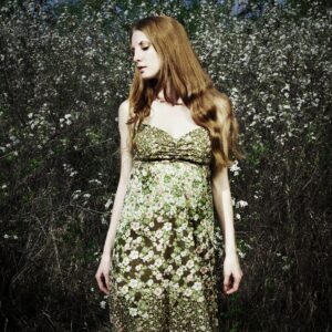 Portrait of the romantic woman in a summer garden